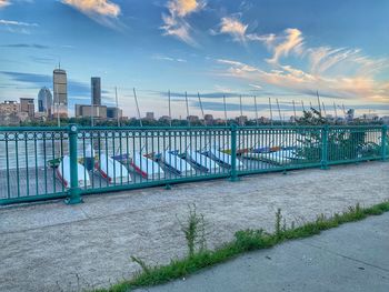 Bridge over river in city against sky