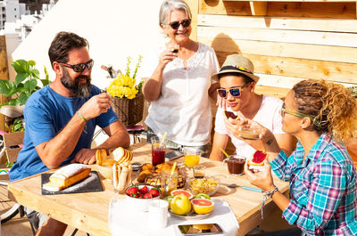 Happy family having breakfast on terrace