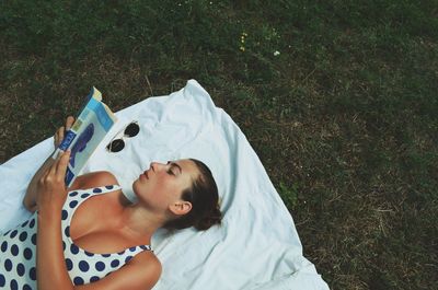 High angle view of woman lying on grass