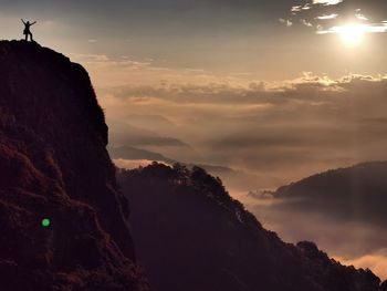 Scenic view of silhouette mountains against sky during sunset
