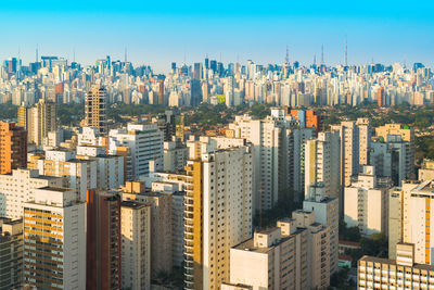 High angle view of modern buildings in city against sky