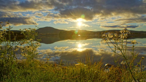 Scenic view of lake against sky during sunset