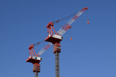 Low angle view of crane against clear sky