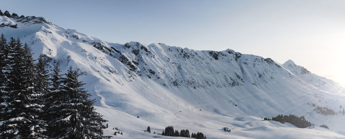 Scenic view of snow mountains against clear sky