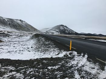 Scenic view of snow covered mountain against sky