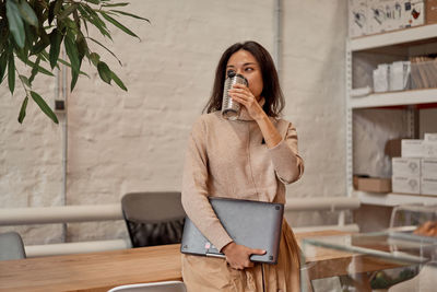 Businesswoman drinking coffee at cafe