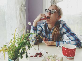 Young woman eating food at home