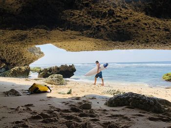 Full length of man on rocks at beach