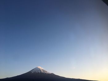 View of volcanic mountain against blue sky