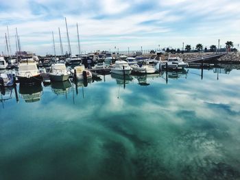 Boats moored in sea against sky