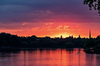 Scenic view of lake against orange sky