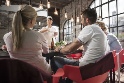 Female chef talking to students in cooking class