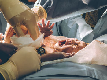 High angle view of woman relaxing on bed