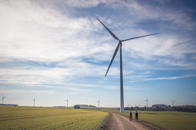 Windmill on field against sky