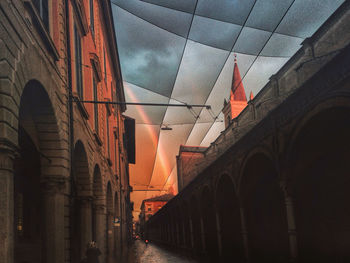 Low angle view of buildings against sky at sunset