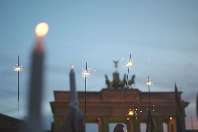 Low angle view of candles and sparkles at brandenburg gate