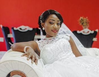 Portrait of bride sitting on sofa