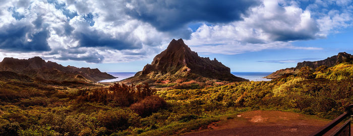 Scenic view of mountains against cloudy sky