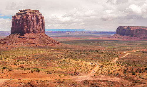 Scenic view of rock formations against cloudy sky