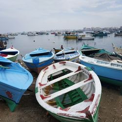 High angle view of boats moored at beach against sky