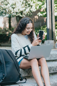 Young woman using phone