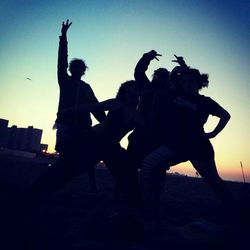 Low angle view of silhouette people at sunset