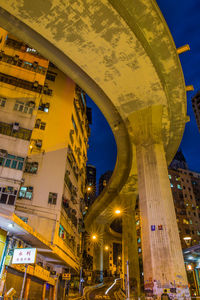 Low angle view of illuminated buildings against sky at night