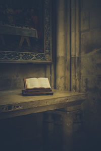 Open book on table in old building