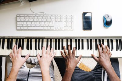 Midsection of men playing piano