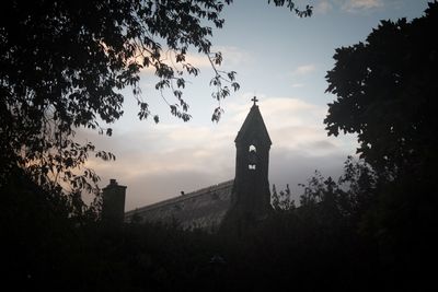 Low angle view of bell tower against sky