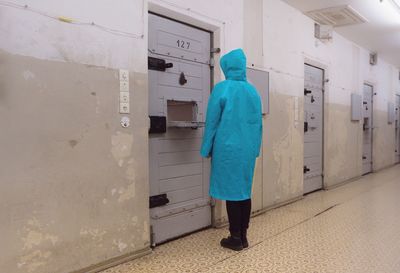 Rear view of woman standing in corridor