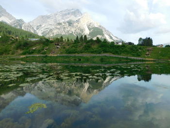 Scenic view of lake and mountains against sky