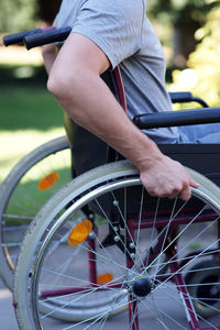 Disabled man using his wheel chair in park closeup