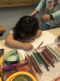 High angle view of girl holding table