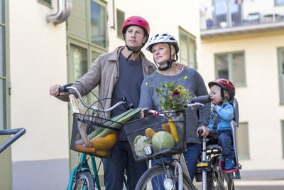 Mid adult couple and child with bicycles