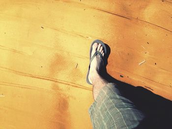 Low section of woman standing on tiled floor