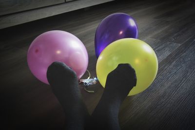 Close-up of hand holding balloons