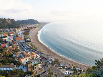 High angle view of townscape by sea against sky