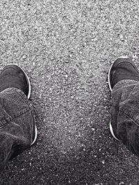 Low section of person standing on road