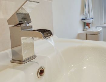 Close-up of faucet in bathroom