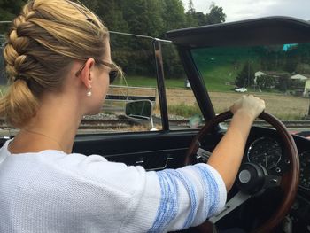 Side view of woman in driving car