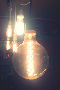 Low angle view of illuminated lamp hanging in row