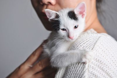 Close-up of woman holding kitten