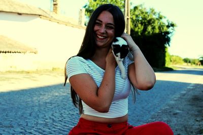 Portrait of smiling young woman standing outdoors