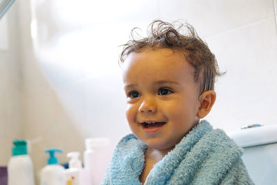 Child playing with shower in bathroom