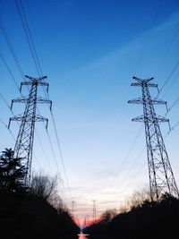 Low angle view of electricity pylon against clear sky