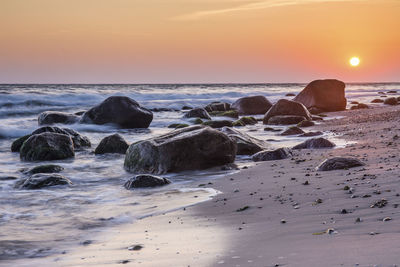 Scenic view of beach against sky during sunset