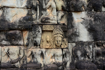 Buddha sculptures carved on temple wall