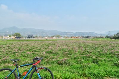 Bicycle on field against sky