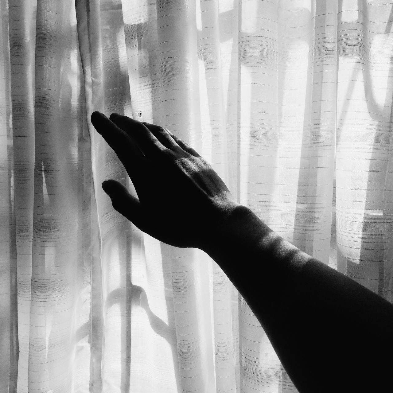 person, indoors, part of, human finger, cropped, lifestyles, unrecognizable person, curtain, close-up, low section, personal perspective, home interior, shadow, leisure activity, holding